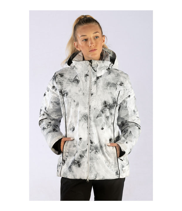 A woman wearing an insulated jacket with light grey with black abstract pattern, featuring a hood, zip closure, and designed for winter wear.