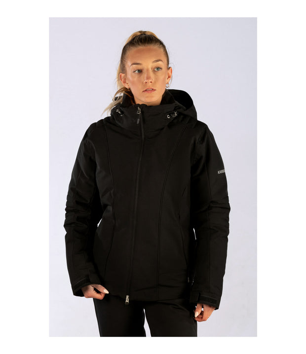 A woman wearing a black insulated ski jacket with black accents, featuring a black hood, full zip closure, and multiple pockets.