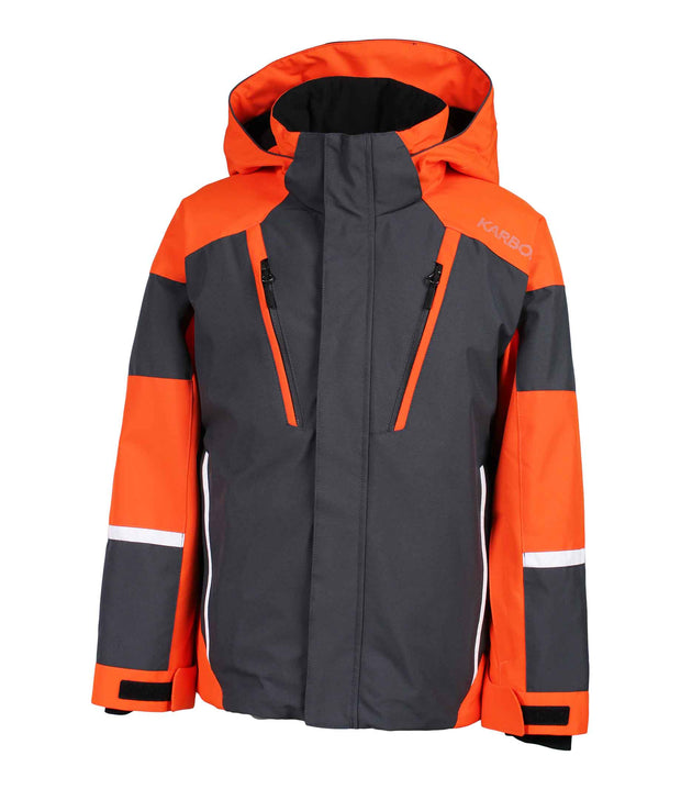 A boys' color-blocked jacket featuring orange and grey panels, with an adjustable hood, front zip closure, and zippered chest pocket with a contrasting light accent stripe. The jacket also includes zippered side pockets and adjustable cuff.